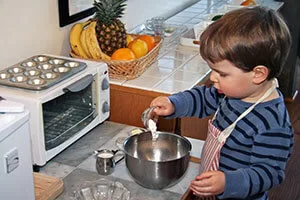baby-in-blue-room-creating-space-for-children-300x200-300x200 Paula Lillard Preschlack - boy at Montessori school in the kitchen.