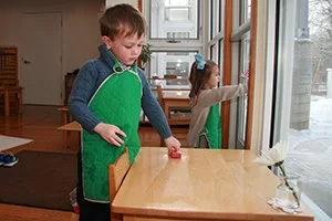 Paula Lillard Preschlack - boy doing a Montessori activity.