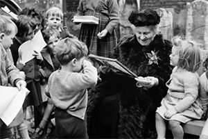 Paula Lillard Preschlack - Maria Montessori with children.
