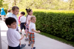 Paula Lillard Preschlack - boys and girls outside standing in line.